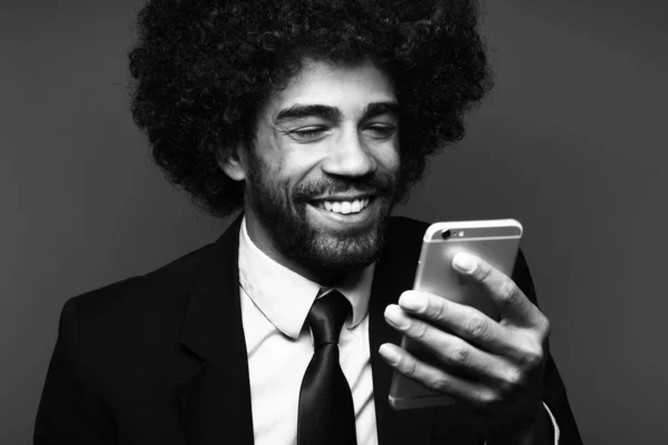 Black businessman using mobile phone on black and white tone