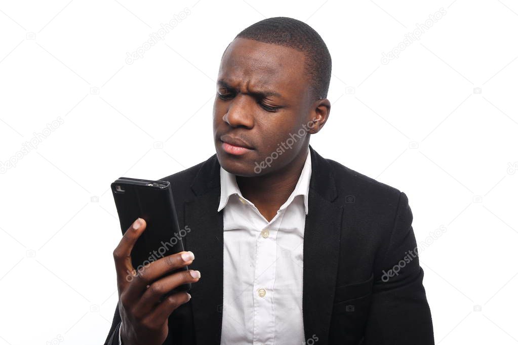 Black businessman holding a mobile phone