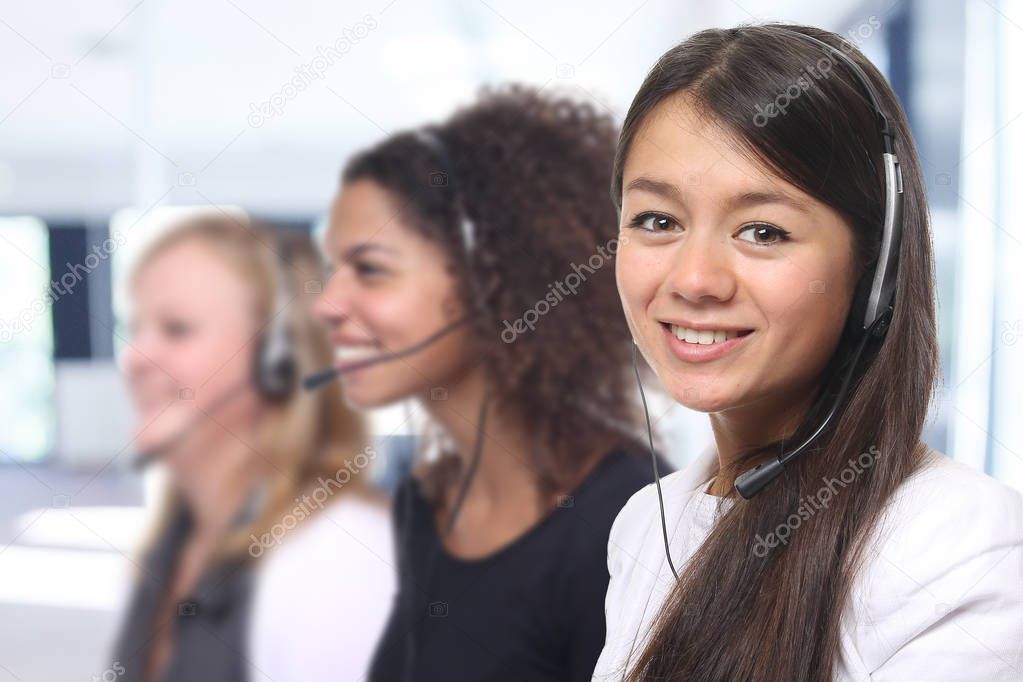 Young girls wearing headphones working in call-center