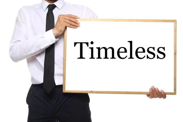 Hombre Negocios Sostiene Pizarra Con Palabra Timeless — Foto de Stock