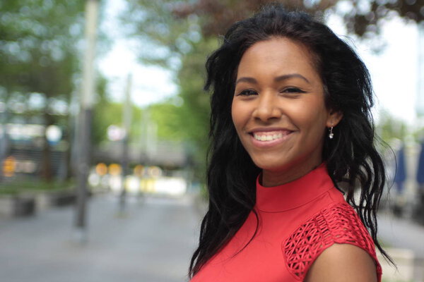 Beautiful afro-american woman is smiling outdoors