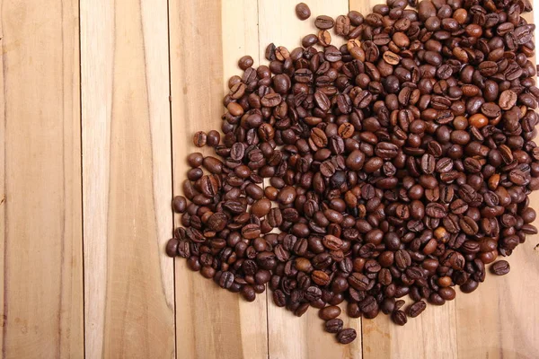 Coffee seeds on wooden background