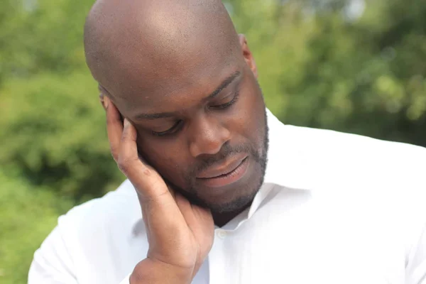 Black man feeling head pain