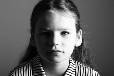 Siyah ve beyaz arka plan üzerinde ciddi küçük kız