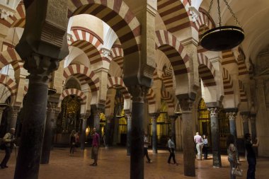 tourists walking through the interior of the Mosque of Cordoba clipart