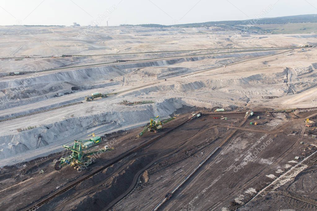 Scenic aerial view of coal mine industry and heavy equipment on quarry