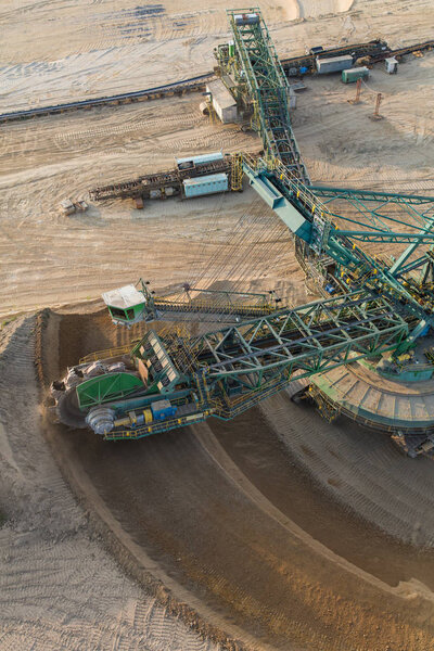 Scenic aerial view of coal mine industry and heavy equipment on quarry