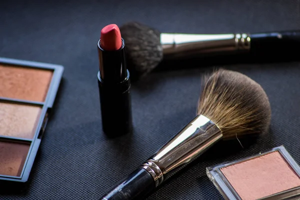 Makeup brush . Face powder bronzer and cosmetic blush brush. Red lipstick