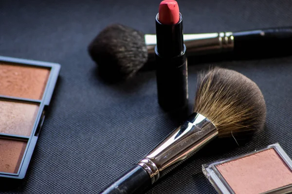 Makeup brush . Face powder bronzer and cosmetic blush brush. Red lipstick