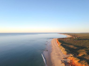 Okyanus plajı, kayalıklar, taşra manzarası, gün batımı gökyüzü ve ufuk kopyalama alanı ile Broome, Batı Avustralya yakınlarındaki uzak sahilin manzara panoramik görünümü.