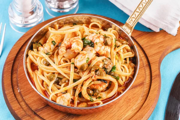 Mediterranean pasta with shrimps, onions, cucumbers and hot peppers
