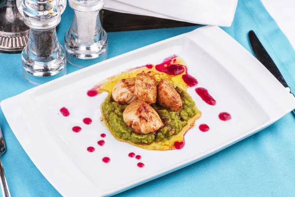 Mediterranean Chicken, on a pillow of pea puree with cranberry sauce
