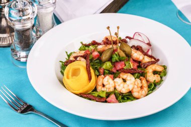 Akdeniz salatası. Arugula, domates, karides, zeytin, zeytin, fesleğen ve biberiye, zeytinyağı ve balsamik sos ile giyinmiş, limon ve biber biber ile süslenmiş