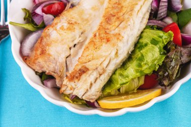 Akdeniz yemeği, Avrupa mutfağı. marul bir yastık üzerinde ızgara beyaz balık biftek- limon, arugula, kırmızı soğan halkaları, marul yaprakları, lahana, zeytinyağı ile domates