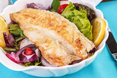 Akdeniz yemeği, Avrupa mutfağı. marul bir yastık üzerinde ızgara beyaz balık biftek- limon, arugula, kırmızı soğan halkaları, marul yaprakları, lahana, zeytinyağı ile domates