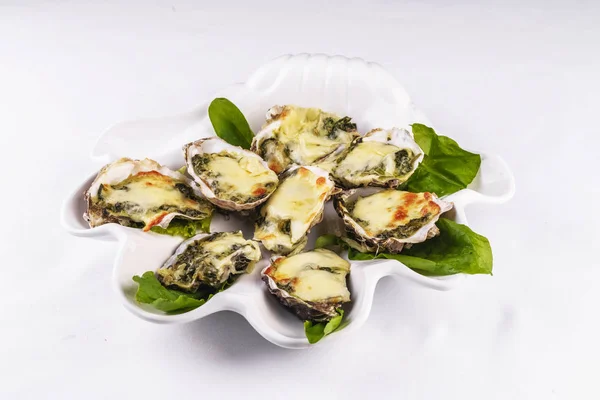 Mediterranean dish, European cuisine. baked mussels under creamy cheese crust with greens