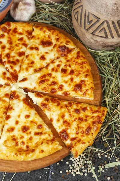 Georgian national dish with khachapuri cheese. flat bread on a yeast dough, baked in an oven with butter, under a cheese crust from caccotto cheese