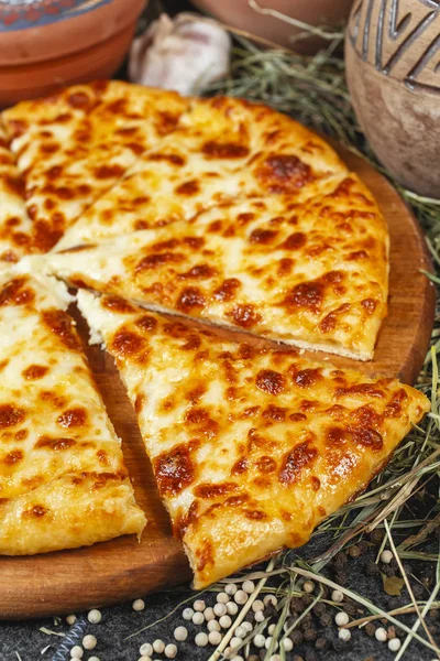 Georgian national dish with khachapuri cheese. flat bread on a yeast dough, baked in an oven with butter, under a cheese crust from caccotto cheese