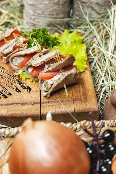 Meat rolls of horse meat with tomato and stuffing, with greens and tomatoes according to the Eastern recipe