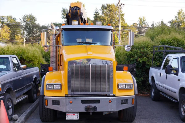 Car repair workshop. Boom truck (rush crane truck) on parking.