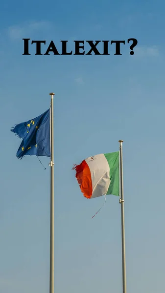 Italy flag and Europe flag waving together on a mast in isolated the blue sky background. Message on top writen Italexit, which is short for Italy Exit of the European Union.