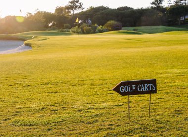 Empty golf course in Algarve, Portugal with signs for golf carts clipart