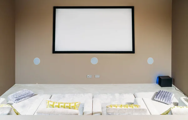 Home cinema with comfortable sofa couches in luxury home