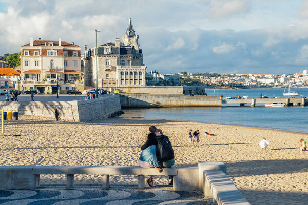 Seaside cityscape of Praia da Ribeira, Cascais. Intimate beach near the train station and popular with tourists