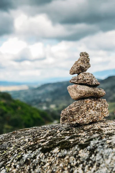 Rock cairn trail marker overlooking a valley in Northeastern Portugal, Europe