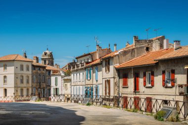Arles in the south of France, typical paved side street of the city center clipart
