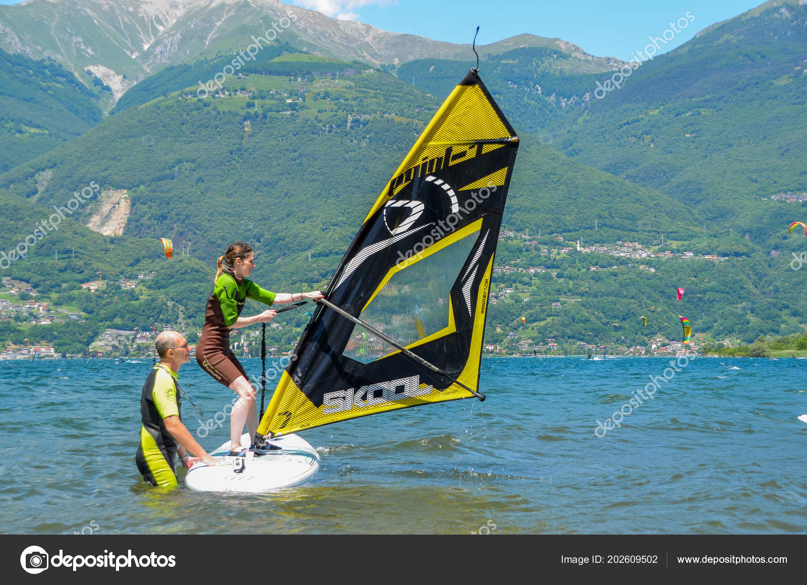 Instructor and students wearing wetsuits on the cold water of Lake Como