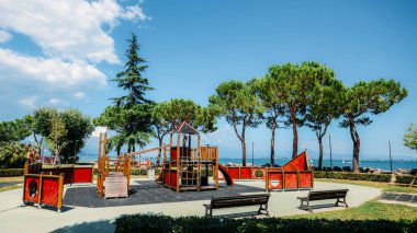 Outdoor adventure playground for kids overlooking beautiful Lake Garda in Lombardy Italy clipart