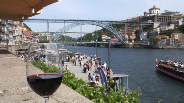 Red, Porto wine glass overlooking tourists at Cais da Ribeira, Porto, Portugal — Stock Video