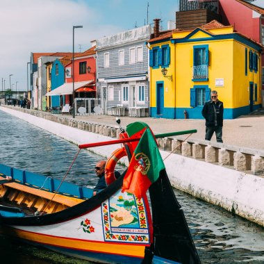 Aveiro, Portugal - April 28, 2019: Traditional boats on the canal in Aveiro, Portugal. Colorful Moliceiro boat rides in Aveiro are popular with tourists to enjoy views of the charming canals. clipart