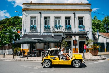 Sarı buggy, Portekiz 'in büyüleyici Azeitao köyünde bir kafenin önünde park etti