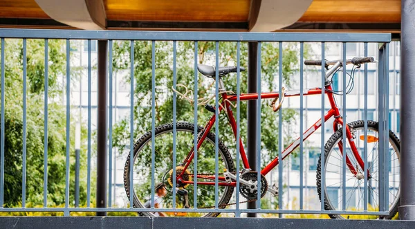 Bike locked to the railing with two locks