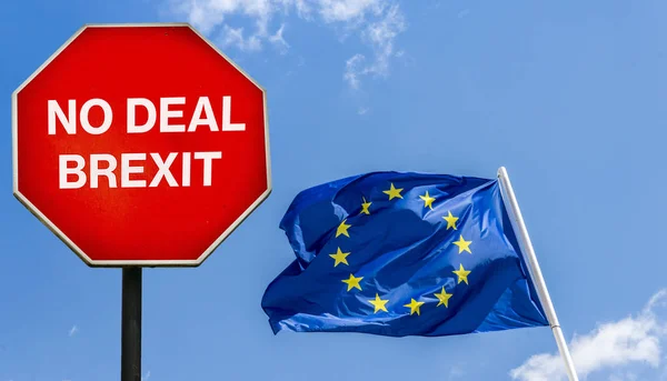 No Deal Brexit written on octagon stop sign with EU flag on background