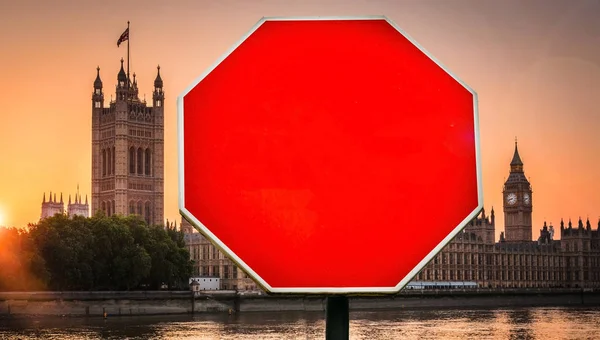 Houses of Parliament, London in background with stop sign in foreground. Insert your own message