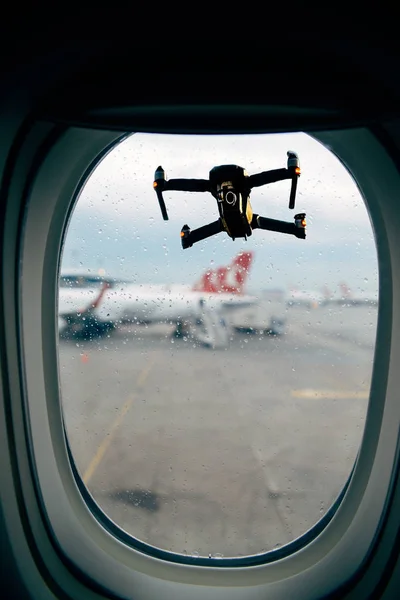 View of drone outside airplane window at airport