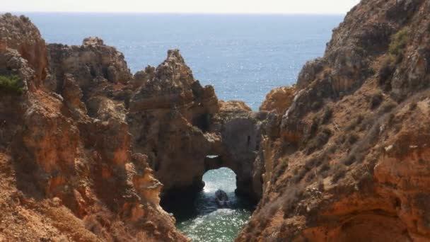 Boat with tourists exit the Ponta da Piedade after exploring its fascinating rock formations in Lagos, Portugal — Stock Video