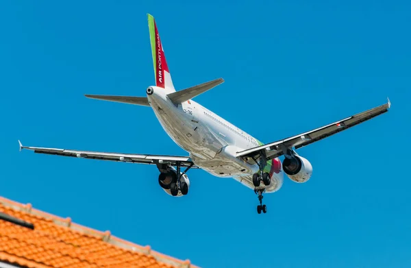 Passenger aircraft Airbus A320 of TAP Portugal Airlines in flight. Blue sky in the background. — Stock Photo, Image