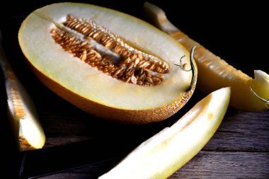 Tahta bir masada dilimlenmiş kavun..