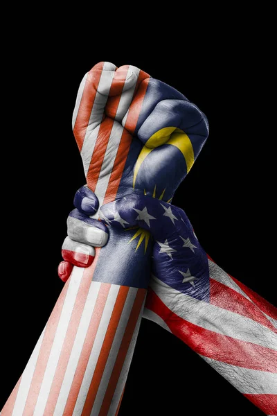 AMERICAN VS Malaysia, Fist painted in colors of Malaysia flag, fist flag, country of Malaysia