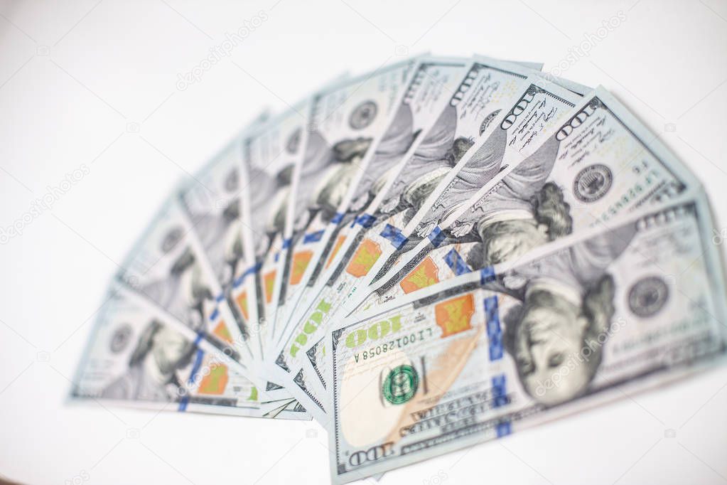 A pile of one hundred US banknotes with president portraits. Cash of hundred dollar bills, dollar background image with high resolution