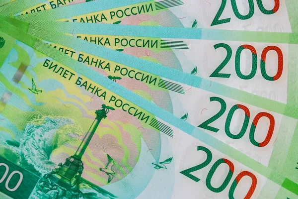 Close up of new Russian currency. Banknotes nominal 200 rubles. Russian paper cash money backgroung.