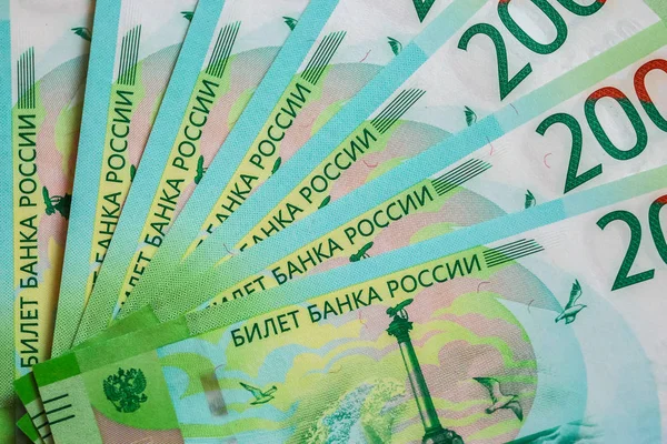 Close up of new Russian currency. Banknotes nominal 200 rubles. Russian paper cash money backgroung.