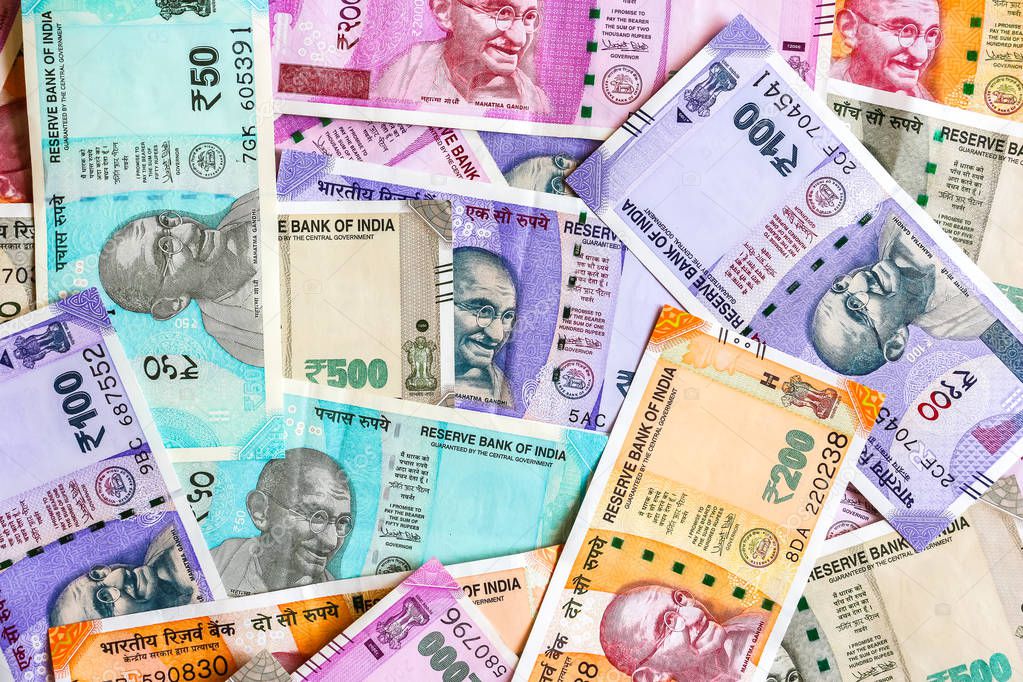 Close up view of brand new indian 50, 100, 200, 500, 2000 rupees banknotes. Colorful cash money background.