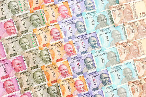 Close up view of brand new indian 10, 50, 100, 200, 500 and 2000 rupees banknotes. Colorful cash money pattern background.