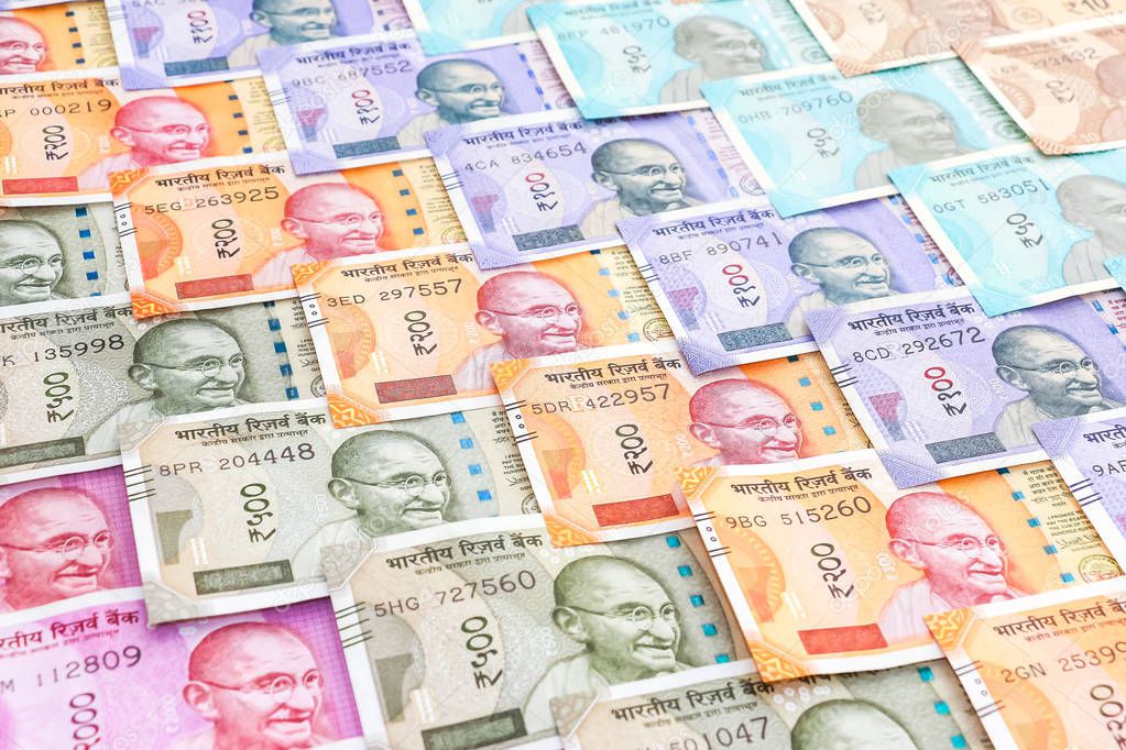 Close up view of brand new indian 10, 50, 100, 200, 500 and 2000 rupees banknotes. Colorful cash money pattern background.