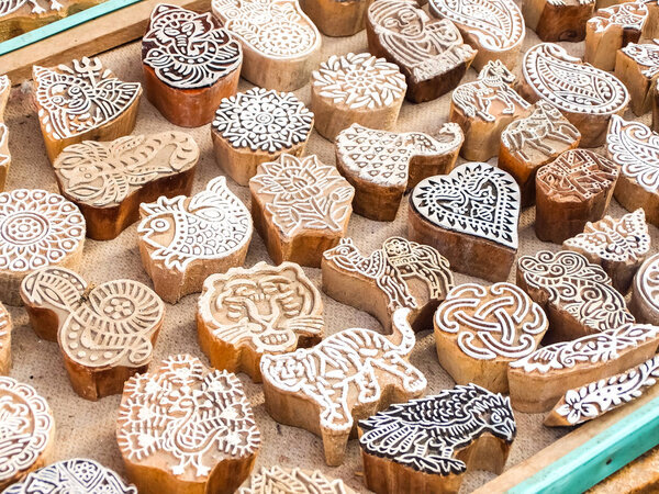 Wooden stamps printing blocks hand carved by artisans on the street market in Jaisalmer, India. Henna stamps for decorating the body or clothes.